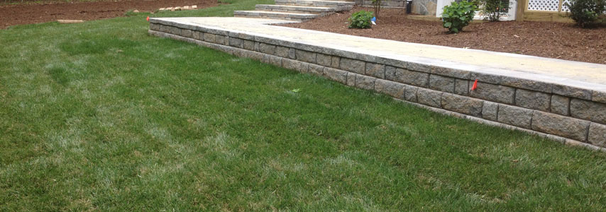 freshly trimmed sod by low landscape wall