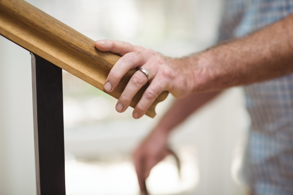 hand on stair railing