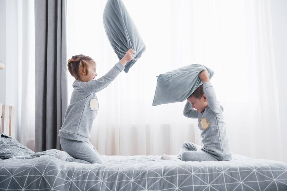 two kids playing in bedroom
