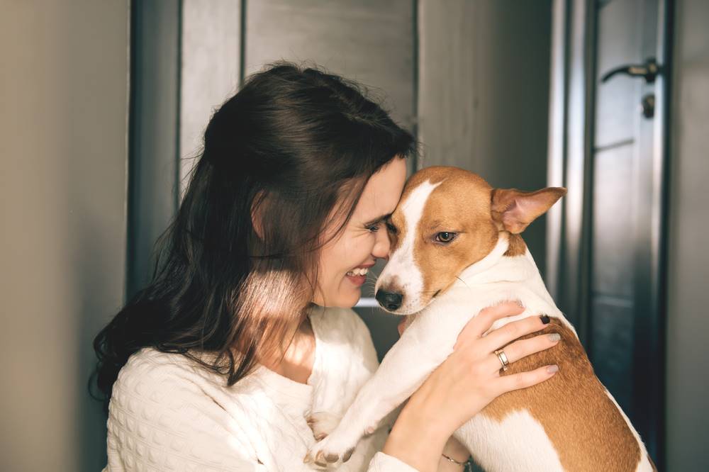 woman hugging dog
