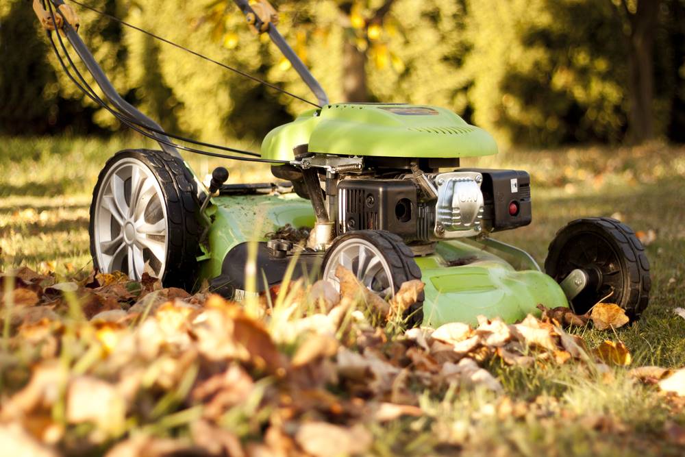 green lawnmower in the fall