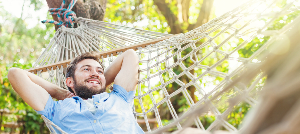 man relaxing on hammock
