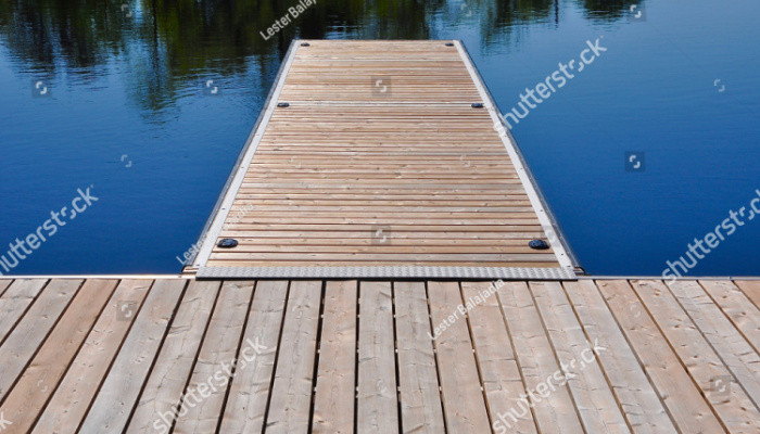 Aesthetically pleasing wooden floating dock in a lake in a sunny day