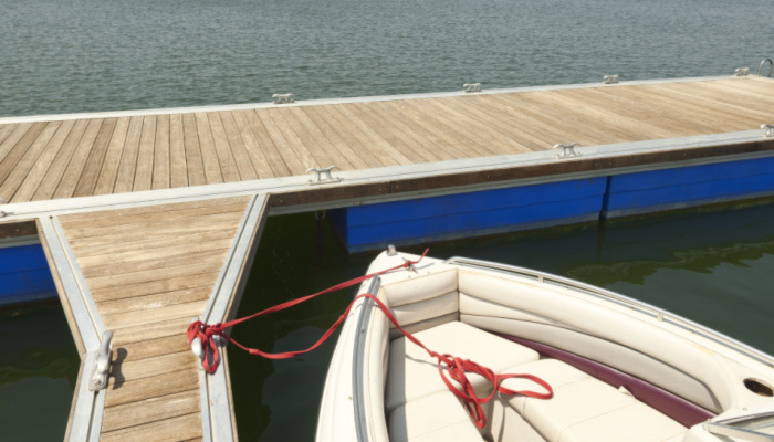 Floating dock on a sea or lake with boat tied up
