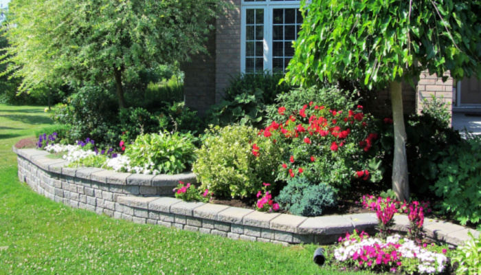 Retaining wall in a beautiful property raised flower bed design and trees with multiple levels