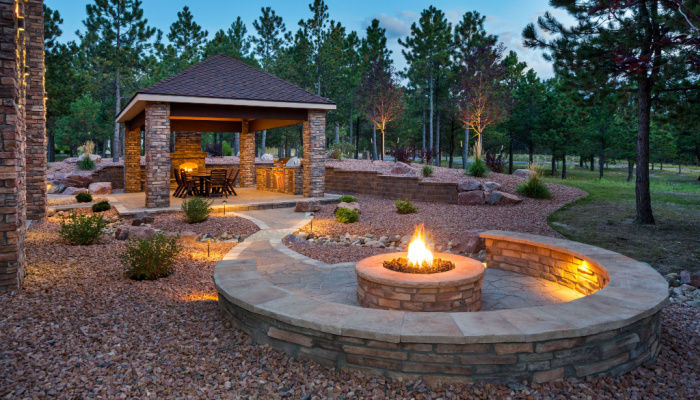 Outdoor living Space and Patio with a fire pit in the evening