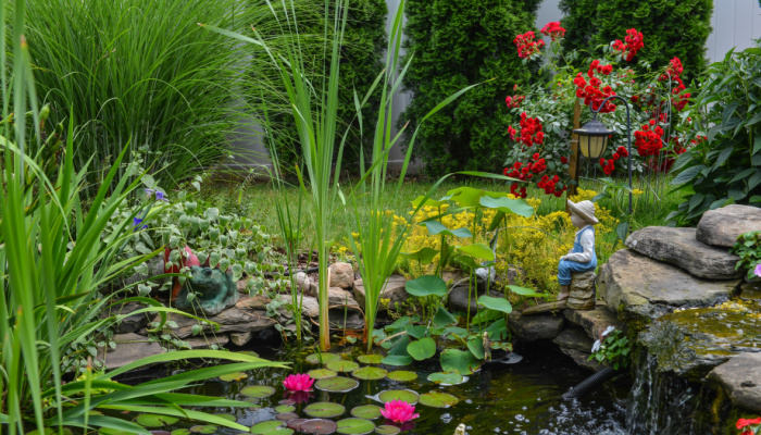 Close view of the water pond feature with the statue and gorgeous plants surrounding it