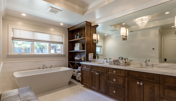 Custom Clean Luxurious Bathroom with large soaking tub and large mirror and window