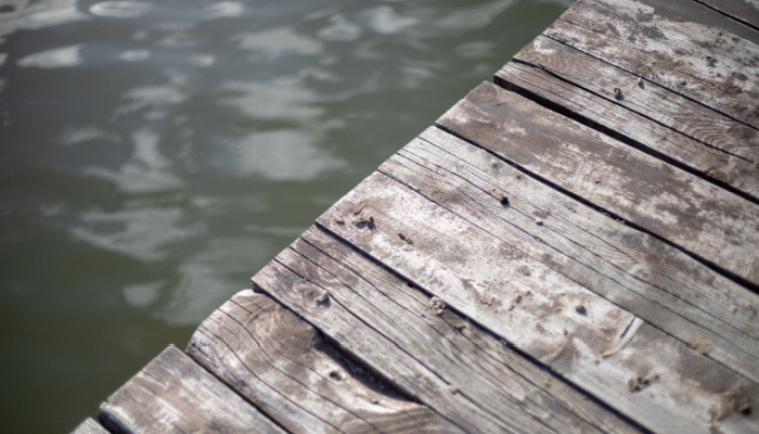 Signs of damage in a wooden dock on the lake